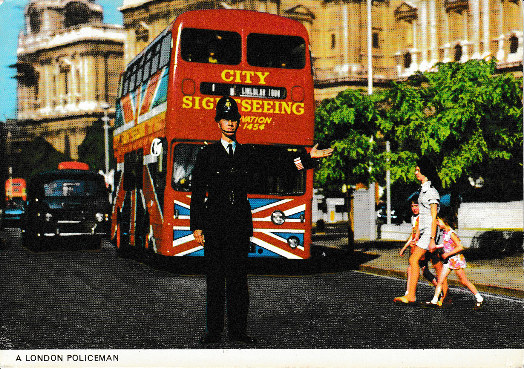 A Policeman directs traffic in London in front of a double decker bus